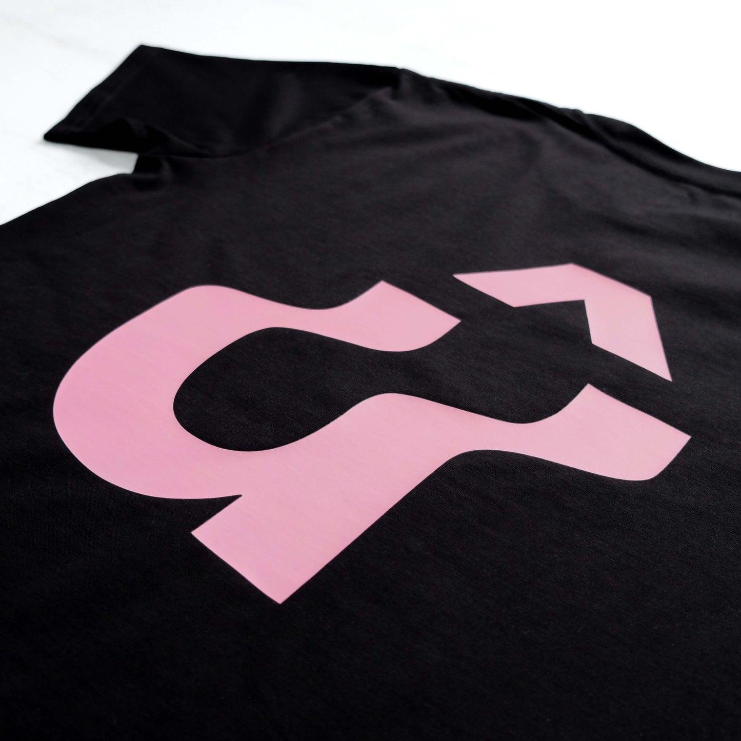 Close up of back of black t-shirt with large pink warped û back print #Warped# - #Up The Road