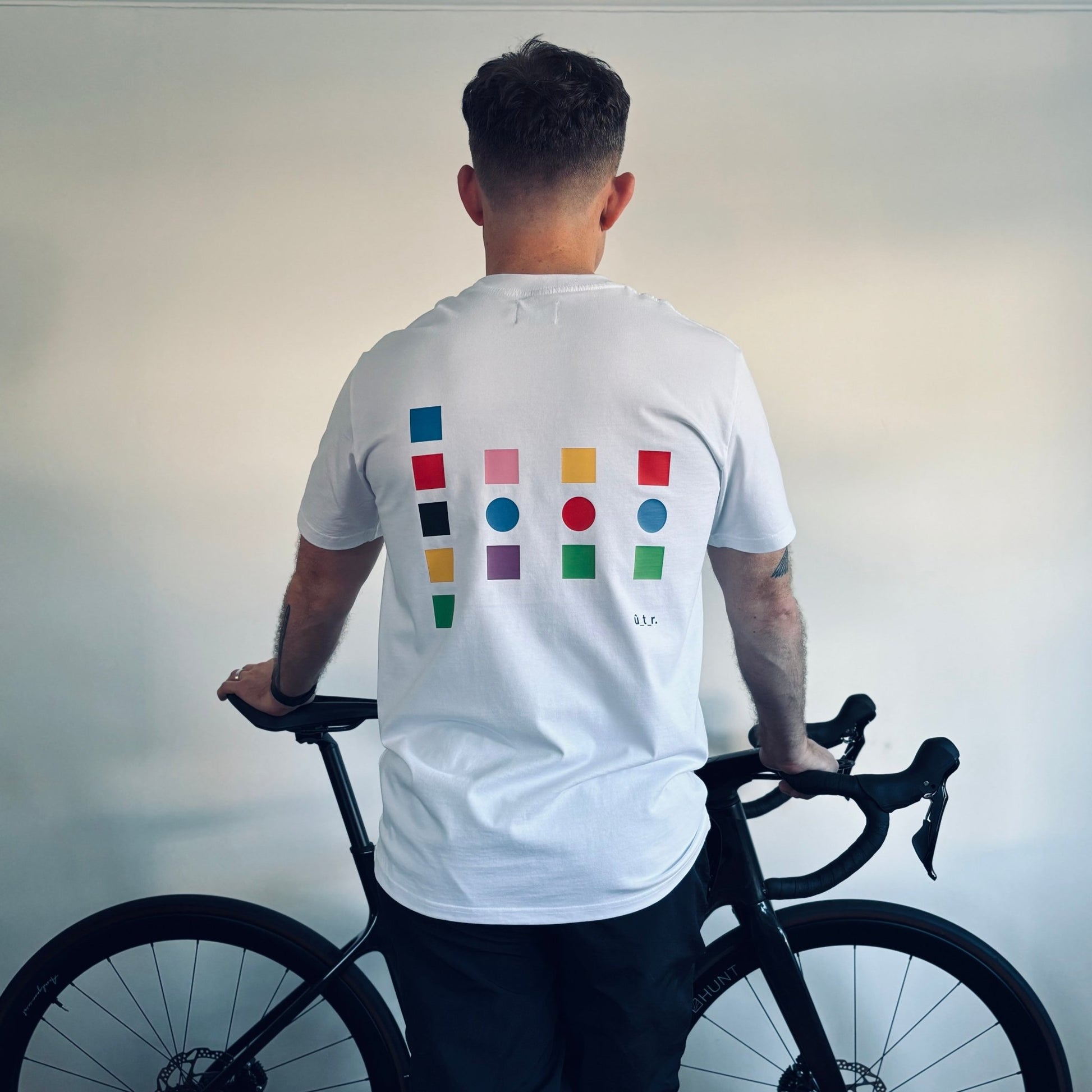 Back of white t-shirt on person. Large back print showing colour swatches that pay homage to the jerseys from the 3 grand tours.. #swatch