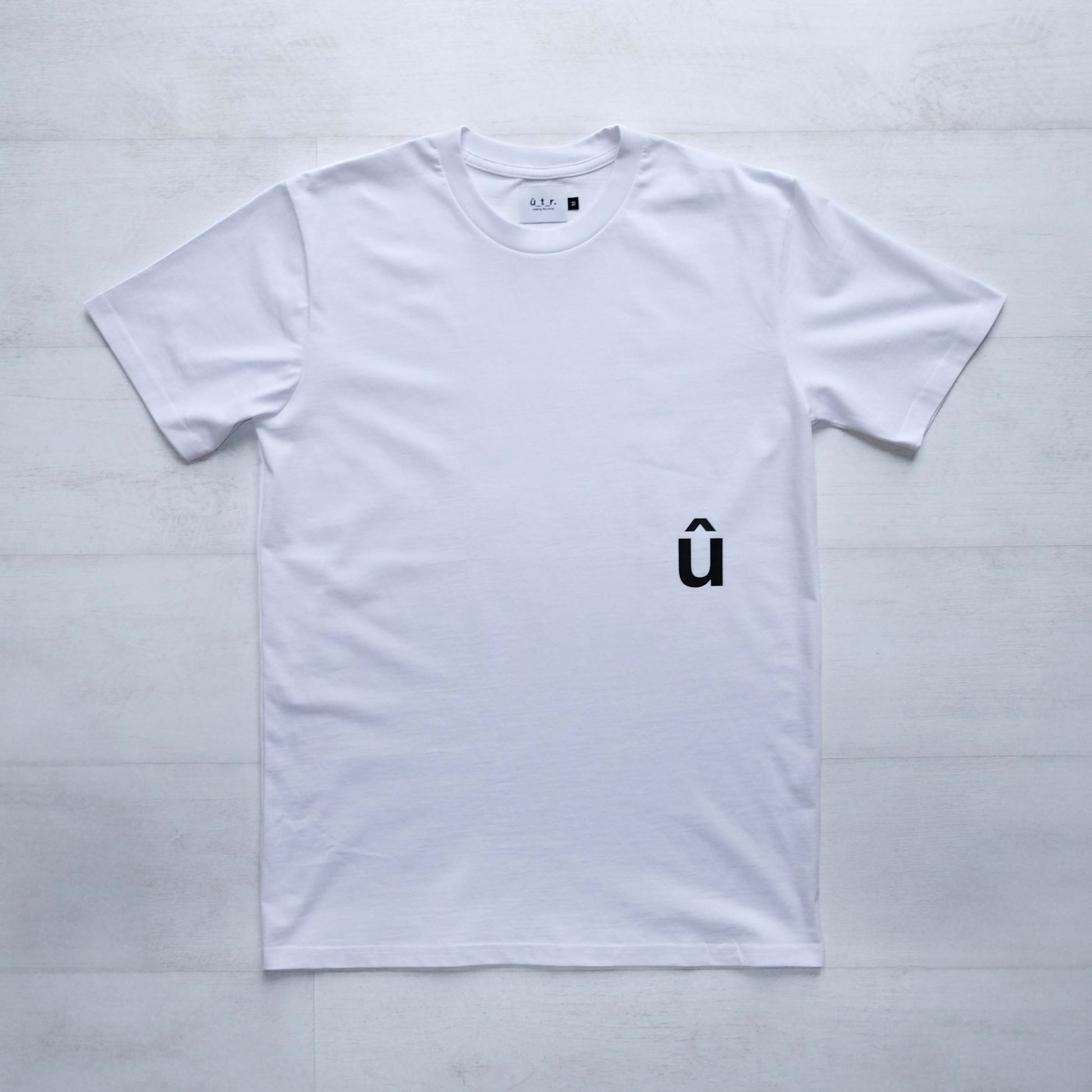 Front of white tshirt with a small black û print below pocket placment #bike #uptheroad